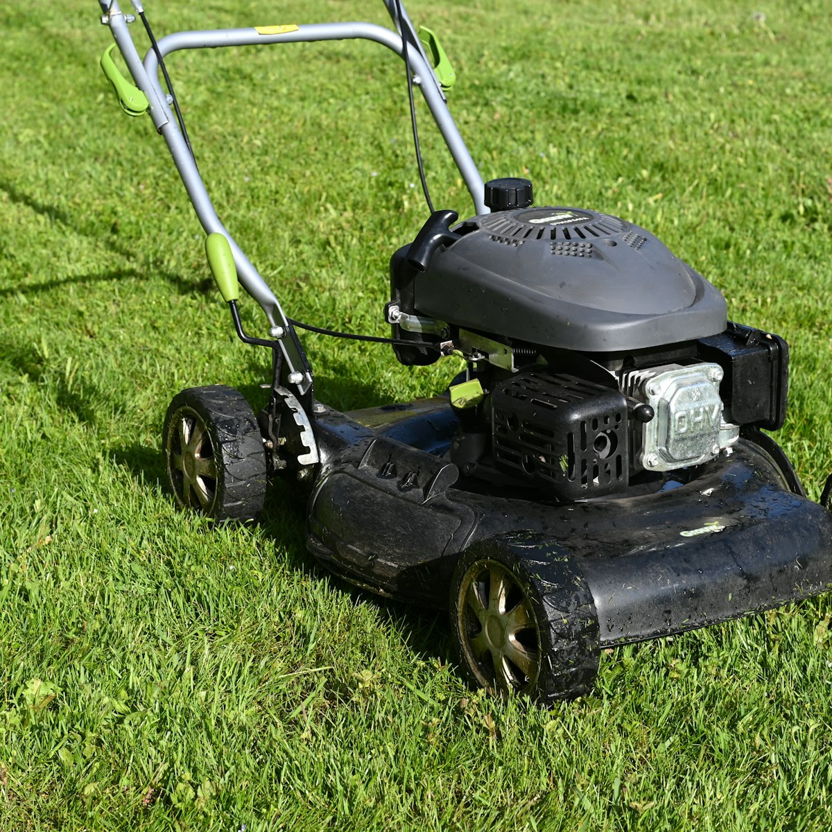 Lawn mower positioned on freshly maintained grass, representing Lawn Care services near me.