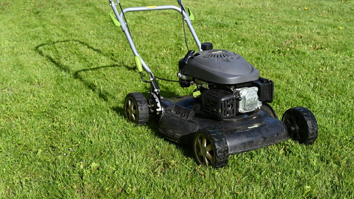 Push lawn mower on green grass for lawn care services in Durham, NH