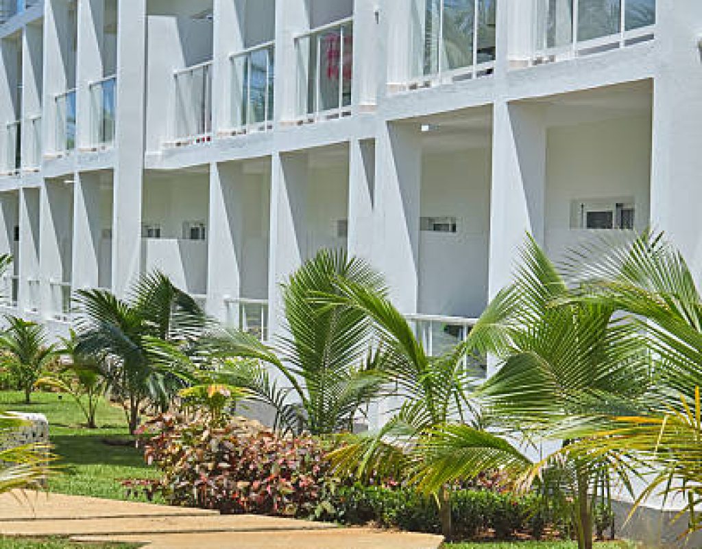 All Natural Landscaping crew mowing large lawn areas with professional equipment.